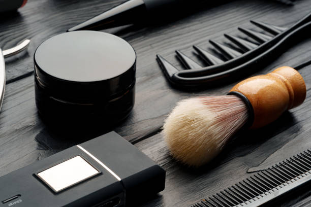 Professional Barber Tools Laid Out on Dark Wooden Surface