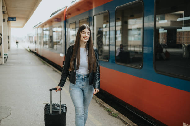 istock Excited young woman going on a trip by train 2113951832