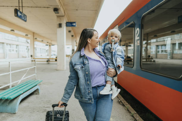 istock Young mother taking her baby boy on a journey by train 2113952089