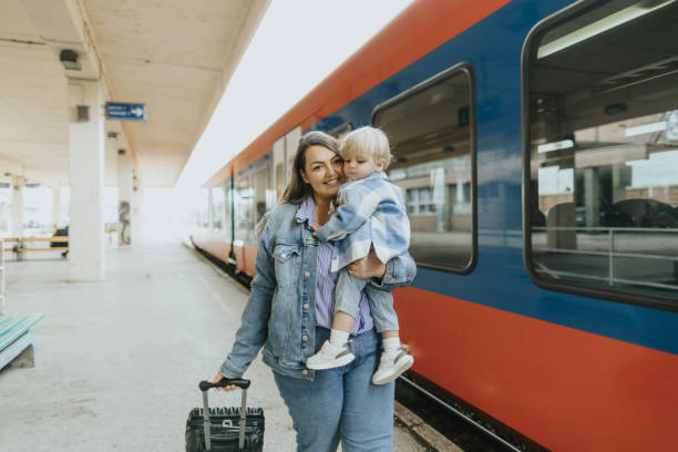 istock Young mother taking her baby boy on a journey by train 2113952240