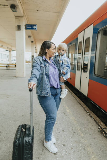 istock Young mother taking her baby boy on a journey by train 2113952356
