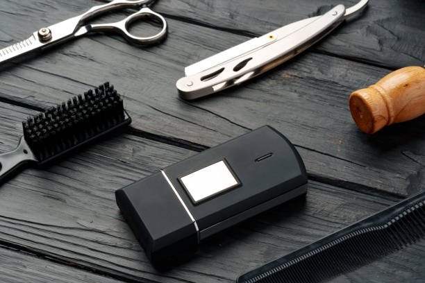 Professional Barber Tools Laid Out on Dark Wooden Surface