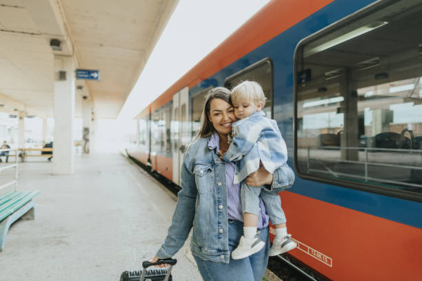 istock Young mother taking her baby boy on a journey by train 2113952392