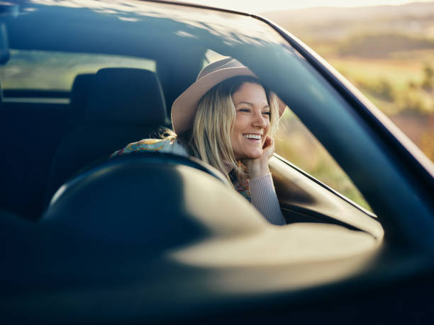 istock Happy woman day dreaming while relaxing in a car. 2113969067