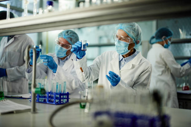 istock Team of scientists working on a research in laboratory. 2113989619