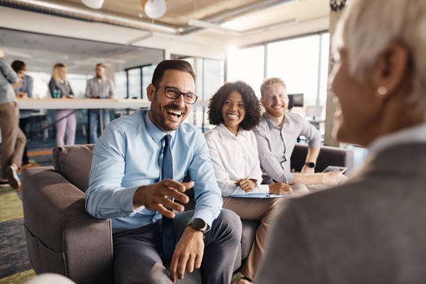 istock Happy businessman talking to his colleague while working in a modern office. 2113994324