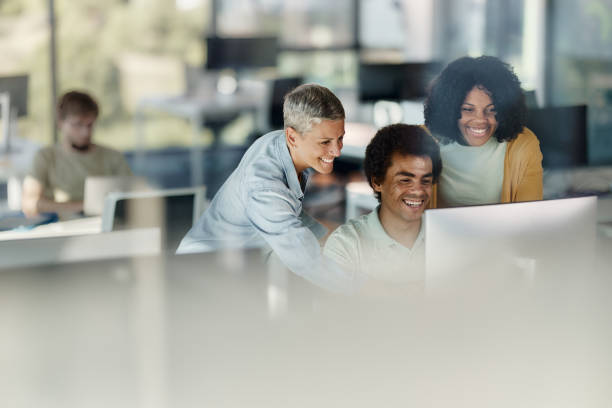 istock Team of happy programmers working on desktop PC in the office. 2114002464