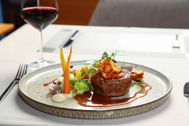 Grilled steak on plate with vegetables Creative steak design in a restaurant. Food photography. white restaurant dishes stock pictures, royalty-free photos & images