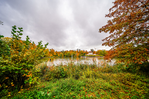 Large pond in Bad Nauheim. Autumnal landscape by the water.