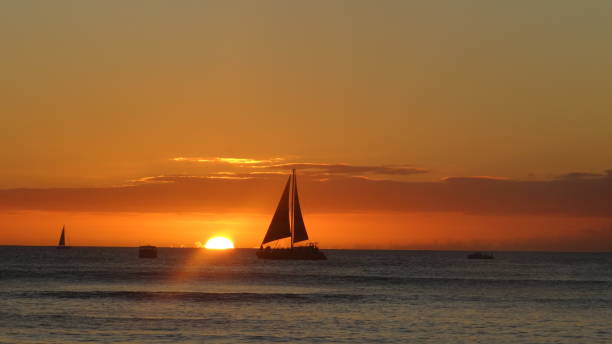 istock Waikiki Sunset Sailboat 2114163429