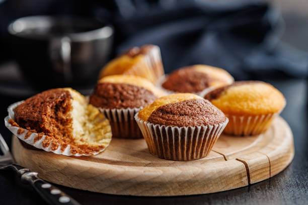 istock Close Up of a Muffins on cutting board on black table. 2114163940