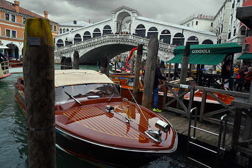 Venice, Italy, march 12, 2024 : Rialto Bridge with a water taxi in the foreground