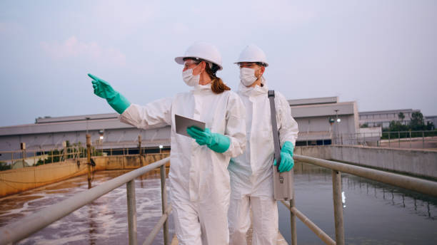 istock Two specialists taking water samples at a sewage treatment plant. 2114186716