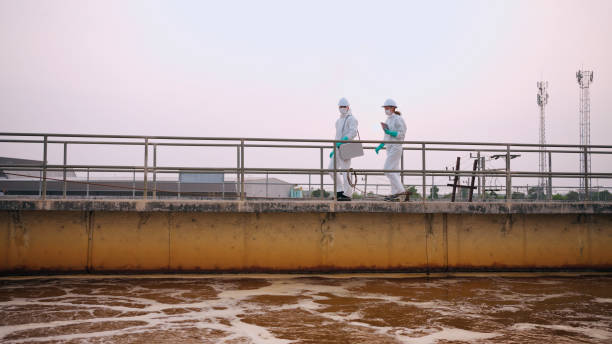 istock Two specialists taking water samples at a sewage treatment plant. 2114186717