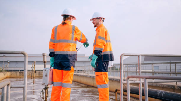 istock Two specialists taking water samples at a sewage treatment plant. 2114186735