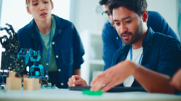 istock New business group teamwork and discuss robot arm in the office. 2114187791