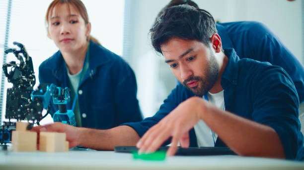 istock New business group teamwork and discuss robot arm in the office. 2114187792