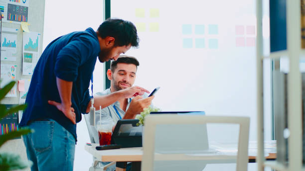 istock Two businessmen having a meeting in a modern office. 2114188344