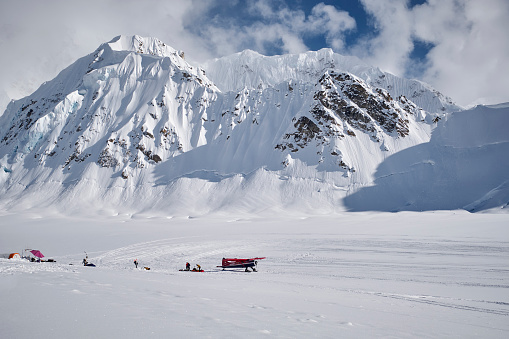 Airplane an some tents on Kahiltna glacier Denali base camp, Alaska, USA
