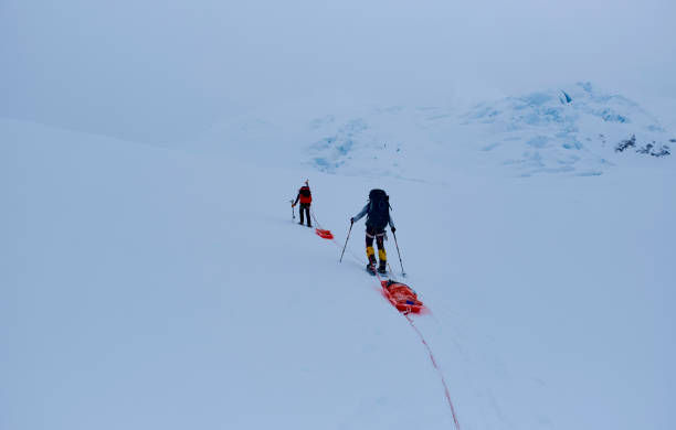 istock Mountain climbers with backpack and pulka on the glacier during their attempt to climb Denali in Alaska. 2114193710