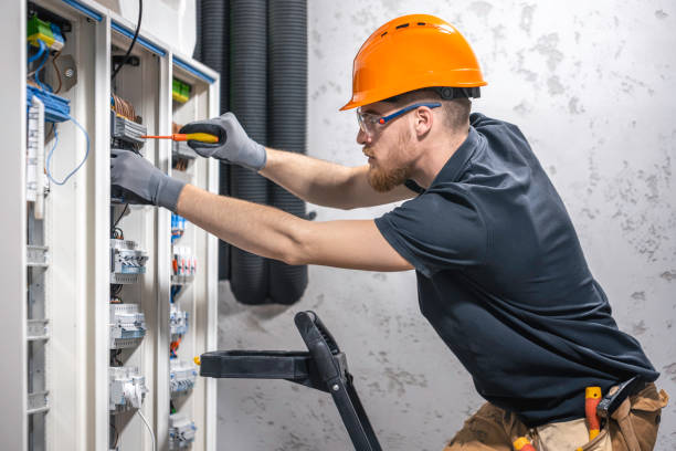 istock Male electrician working in a switchboard with fuses. 2114200572