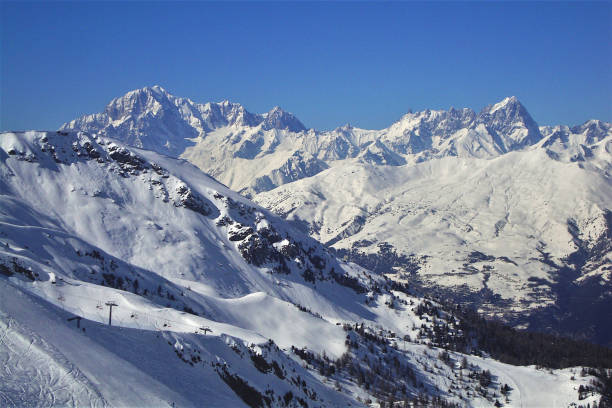 Snow covered mountain landscape in the French Savoie Alps region in the Val Thorens ski area resort during a beautiful clear winter day..