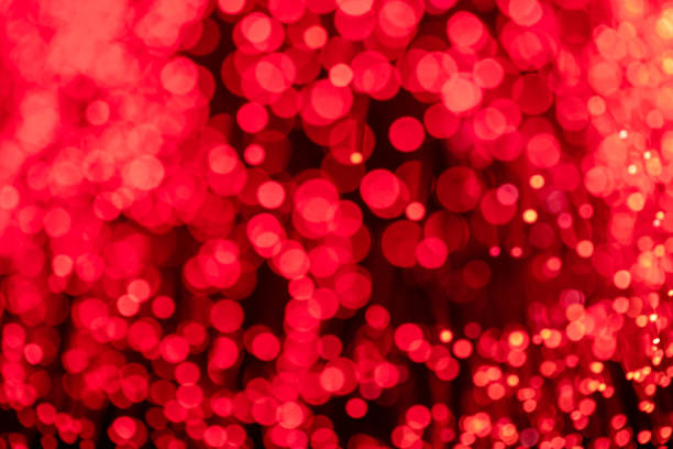 Abstract background of blurred lights with bokeh effect. Red glitter vintage lights background, defocused
