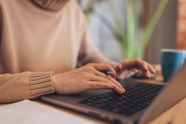 istock Woman using laptop at home 2114258498