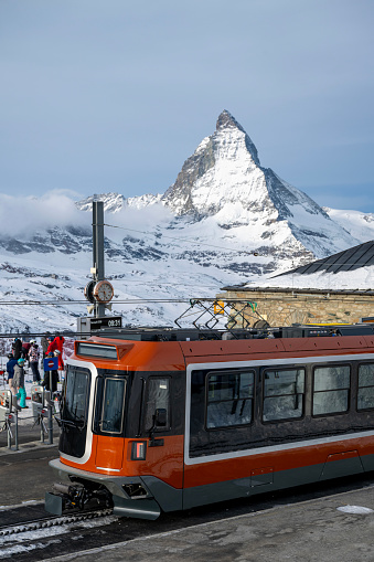 Gornergrat Train arrives at station below Matterhorn mountain in winter