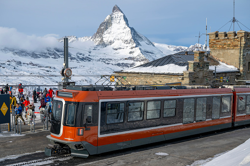 Gornergrat Train arrives at station below Matterhorn mountain in winter