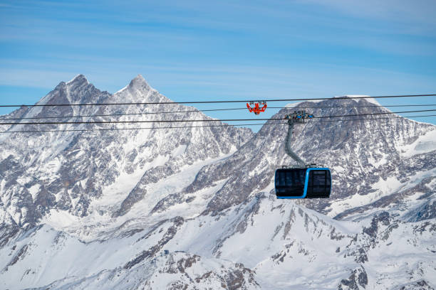 istock Snowcapped mountains and cable-car 2114270218