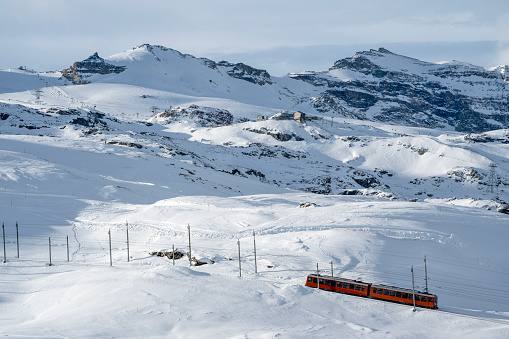 View down Gornergrat train traveling through snowy landscape, Zermatt