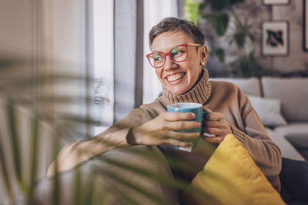 istock Woman sitting at home 2114284778