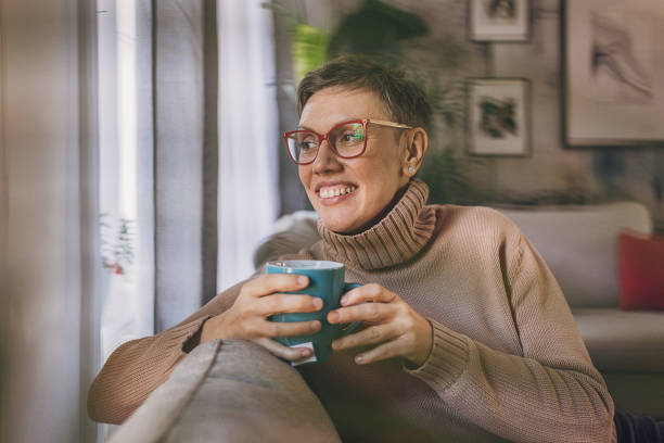 istock Woman sitting at home 2114286604