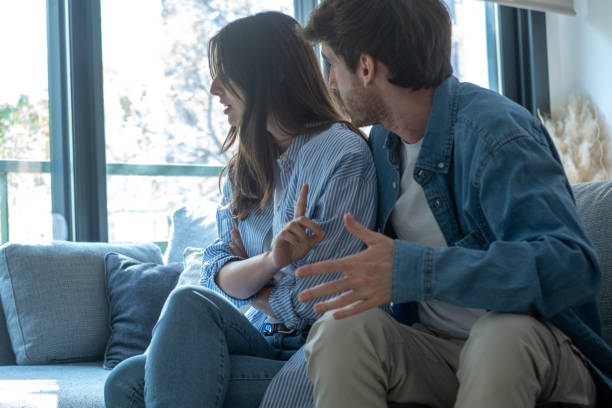 cặp đôi ngồi trên ghế sofa với những vấn đề và mối quan hệ tan vỡ, thảo luận và nói chuyện buồn và thất vọng - cuộc nói chuyện cặp đôi tức giận hình ảnh sẵn có, bức ảnh & hình ảnh trả phí bản quyền một lần