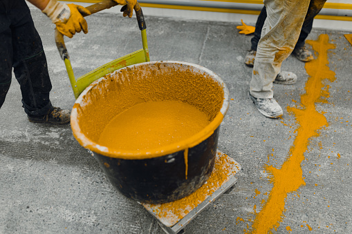 epoxy flooring applicator performs painting works with polyurethane epoxy mortar