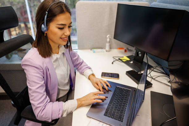 istock Friendly female call center operator working in office 2114305453