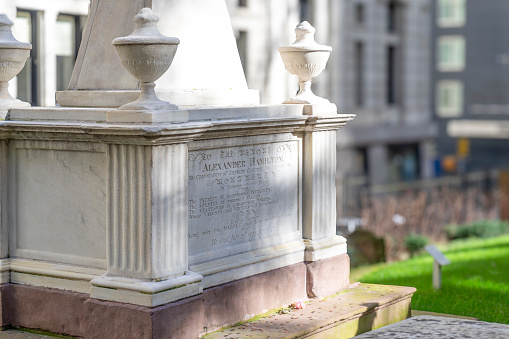 Trinity Church, Manhattan, New York, USA - March, 2024. Alexander Hamilton tomb in Trinity Church cemetery in the heart of the Wall Street Financial district of Manhattan.