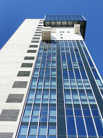 Contemporary building facade composition made of concrete ang glass