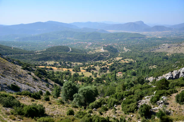 istock valley with green trees and mountain range on background view point 2114318690