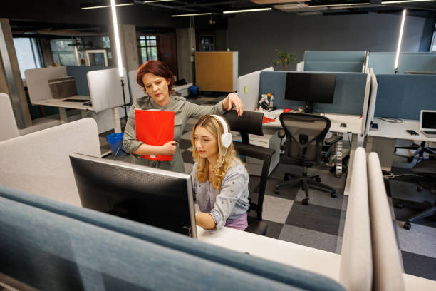 istock Mature manager supervising work of employees 2114325773
