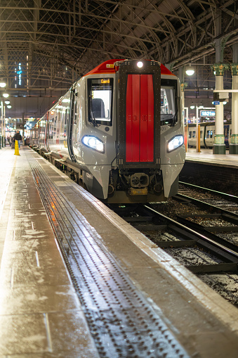 A train standing at the platform on a damp winters evening