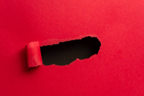 istock red paper with holes 2114327336