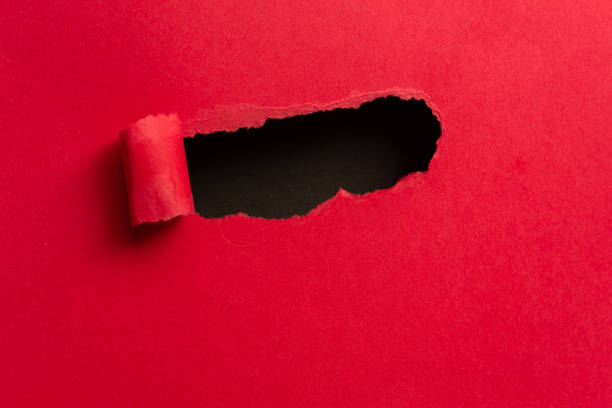 istock red paper with holes 2114327346