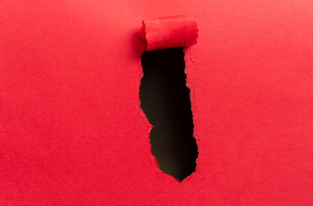 istock red paper with holes 2114327352