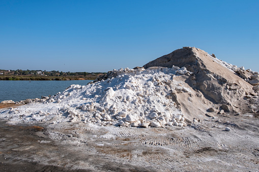 Piles of salt in the salt flats of Iptuci in Prado del Rey, Cadiz province, Andalusia, Spain. Settling ponds for salt production by evaporation.