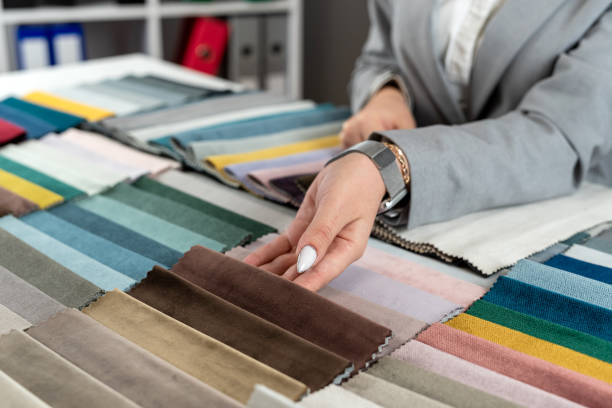 istock female hand selects the color fabric catalog she likes for new sofa 2114356645