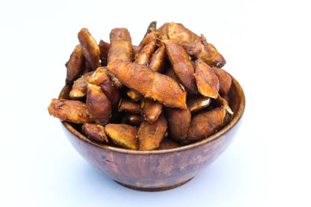 Peeled Tamarind fruits in a wooden bowl