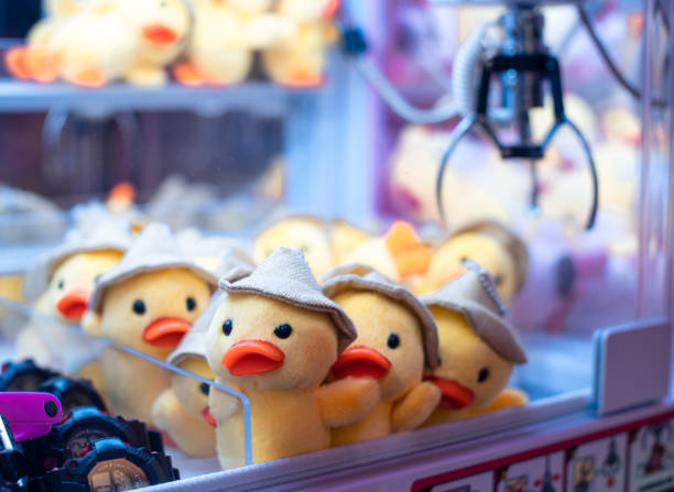Seville, Spain April 20, 2024: side image of a tombola of the Seville fair, where you can see the gifts hanging very colorful and cheerful, people watching and walking