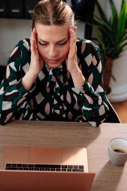 istock Female employee looking sad in the office 2114403869